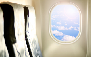 An interior view of a row of airplane seats and a window, where epoxy resin adds strength.