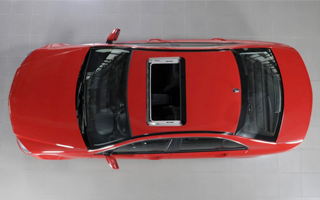 A red sedan, seen from above, with polycarbonate parts to improve fuel efficiency and safety.