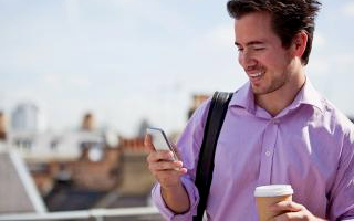 A man checks his cell phone, made using polycarbonate plastics and BPA.