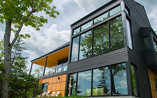 Polycarbonates is used in architectural glazing, like in this modern building with floor to ceiling windows.