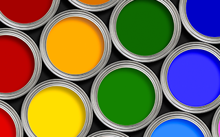 A view from above of paint cans containing red, yellow, orange, and green paints which may contain epoxy resins.