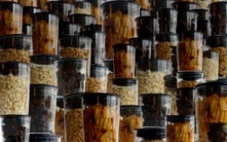Stacks of polycarbonate plastic jars full of spices and herbs. 