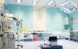 An operating room, with table, lights, and various medical equipment and many examples of polycarbonate plastic medical applications.